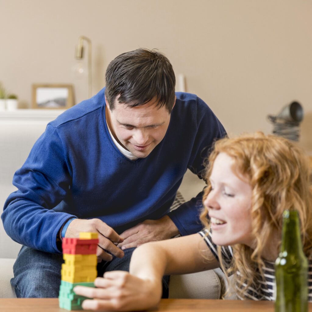man woman playing games home while having beer